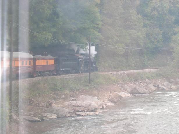 [Here you can see the locomotive through the window of our rail car, as we round a bend.]