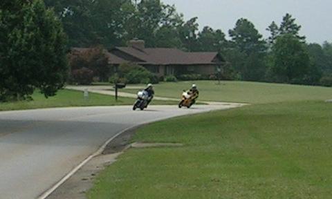 [09/04/06: Vicki leading Terry through a mild curve on the back side of the subdivision. First picture of us riding together, but on our own bikes.]