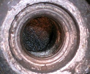 [Looking at the top of the vertical piston through the spark plug hole.]