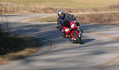 [Vicki going through an S-curve on a nice country backroad.]